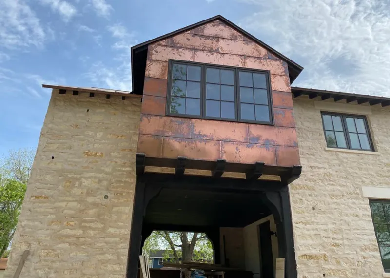 Copper metal panel facade on a stone building for Metal Roof Coating in Prairie View