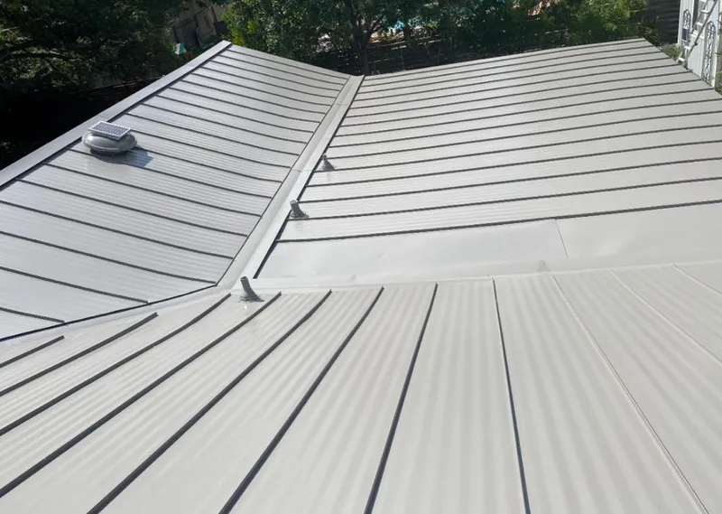 Solar attic fan installed on a metal roof for Roof Ventilation in Prairie View